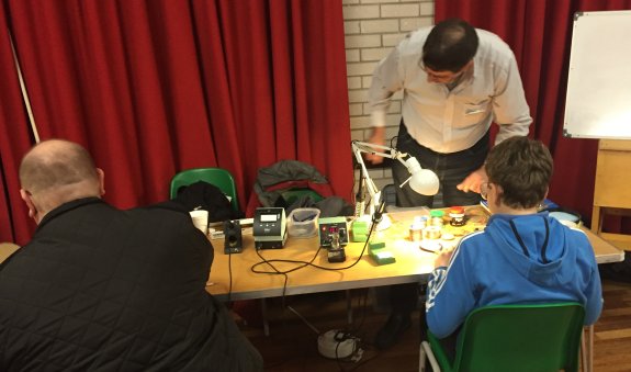 Dave G4HUP helping with soldering at Suffolk RED - Dec 2015