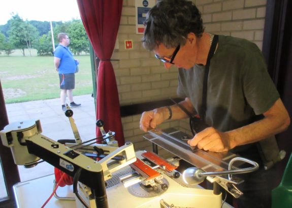 Jim 2E0JTW engraving custom callsign badges and pens at Suffolk RED